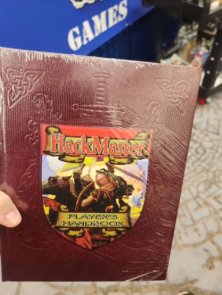 Man holding hackmaster hardcover